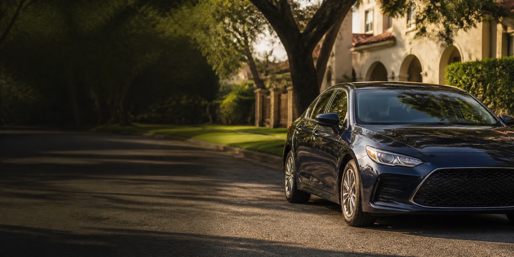 A sedan parked on a tree-lined Houston neighborhood street